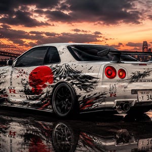 May include: A white Nissan Skyline GT-R R34 sports car featuring a black and red graphic design of a sun and mountain. The vehicle has black wheels, a rear spoiler, and a license plate reading Y 34. The car is parked near a body of water.