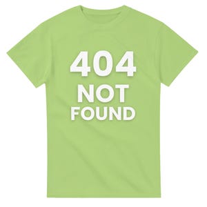 May include: A pale green t-shirt featuring the text "404 NOT FOUND" in large, white, bold lettering. The shirt has a crew neck and is a solid colour. The text is centrally positioned on the front of the garment.