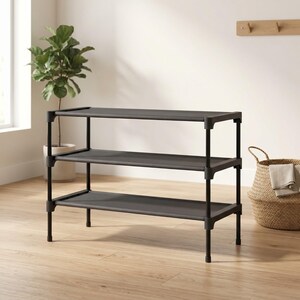 May include: A three-tiered, dark gray shoe rack with a black metal frame. The rack has three shelves and is designed for organizing shoes. The rack is approximately 30 inches wide, 12 inches deep, and 24 inches tall.