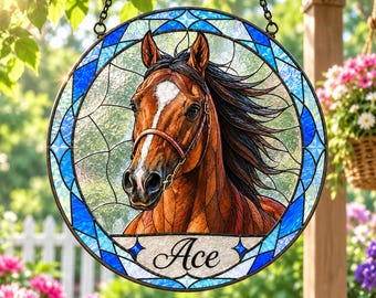 May include: A circular stained glass suncatcher featuring a brown horse with a white blaze on its face and a black mane. The horse wears a brown bridle. The name Ace is written in black script on a white banner at the bottom of the glass panel.