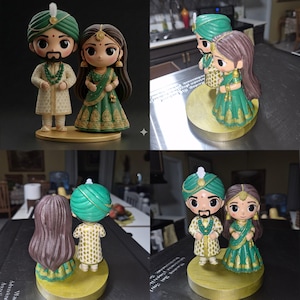 May include: A pair of stylised figurines depicting a couple in traditional Indian wedding attire. The figure on the left wears a green turban and cream-coloured sherwani, while the figure on the right wears a green lehenga with gold embroidery.