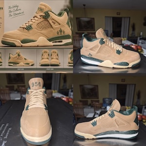 May include: Tan suede trainers with dark green accents, featuring a mesh side panel, a cactus graphic on the heel, and the number 956 embroidered on the tongue. The design includes a speckled midsole, matching tan laces, and a structured high-top silhouette.