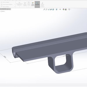 May include: A 3D computer-aided design model of a grey mechanical component featuring a flat rectangular top plate integrated with a central hollow square-shaped base. The digital rendering displays technical dimension lines and numerical annotations.