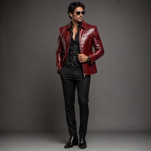 May include: A full-length shot of a person wearing a red, textured leather jacket with a zipper closure. The jacket is paired with a black shirt, vest, and pants. The person is also wearing sunglasses and black shoes.