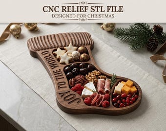 May include: A dark wood serving board shaped like a Christmas stocking with the text "JOY TO THE WORLD" carved into the side. The board features multiple interior compartments filled with various snacks including cheese, berries, nuts, and meats.