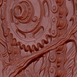 May include: A monochromatic reddish-brown relief sculpture featuring a central mechanical gear assembly integrated with a metal drive chain, surrounded by intricate, flowing organic branch-like patterns carved into the surface.