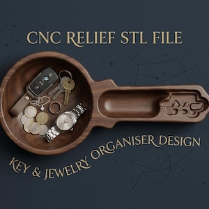May include: A dark wood key and jewellery organiser shaped like a large key, featuring a circular bowl containing a car key fob, metal keys, a ring, coins, and a silver wristwatch, with the text CNC RELIEF STL FILE KEY & JEWELRY ORGANISER DESIGN.