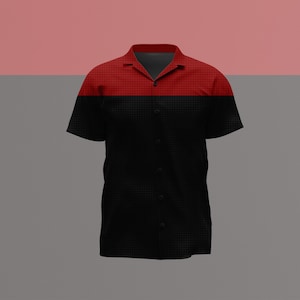 Puede incluir: Una camisa de manga corta con botones que presenta un diseño de bloques de color con una sección superior de color rojo oscuro y una sección inferior negra. La prenda tiene un cuello clásico, una tapeta central y un sutil patrón de rejilla.