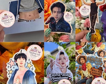 May include: A collection of die-cut vinyl stickers featuring various portraits and illustrations of a person, including a cowboy-themed design with the text World Wide Handsome and Howdy, and another with the text World Wide Handsome.