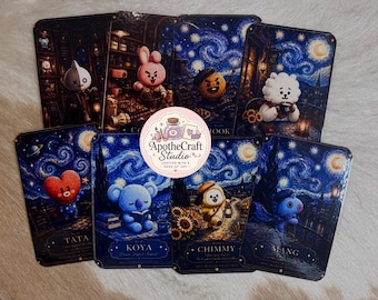 May include: A collection of eight rectangular cards featuring stylized cartoon characters set against dark blue, swirling night sky backgrounds. Each card displays a unique character, including Tata, Koya, Chimmy, and Mang, with a circular logo in the center reading ApotheCraft Studio Crafted with a dose of joy.