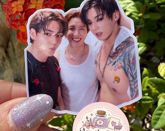 May include: A die-cut sticker featuring a photographic print of three individuals with dark hair, including one person wearing a black shirt, one in a white tank top, and one shirtless with visible arm tattoos. A circular logo sticker reads ApotheCraft Studio.