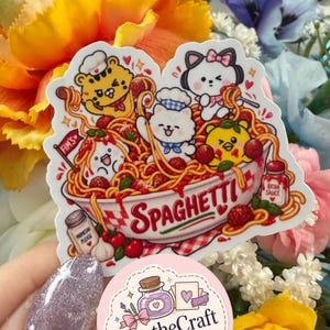 May include: A die-cut sticker featuring a bowl of spaghetti with cartoon characters, including a tiger, a cat, and a bear, with text reading SPAGHETTI, PARMESAN PLEASE, FIM'S, and EXTRA SAUCE, alongside a circular logo for ApotheCraft Studio.