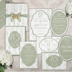 May include: A sage green and white wedding stationery suite featuring floral patterns, ornate frames, and a gold wax seal. The set includes rectangular and oval cards with printed text, monograms, and RSVP details, accompanied by a matching envelope.