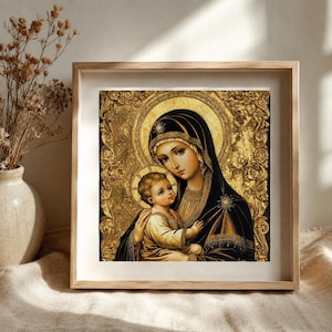 May include: A framed wall art print featuring a religious icon of a mother and child in a gold-toned colour palette. The artwork depicts two figures with halos, surrounded by an ornate, textured gold border, presented in a light wood frame.