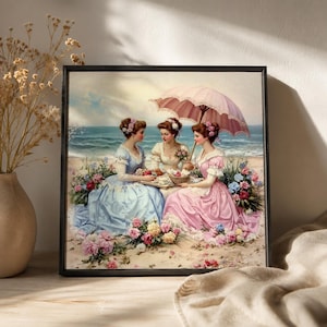 Könnte beinhalten: Ein gerahmter Kunstdruck, der drei Personen in historischer Kleidung an einem Sandstrand zeigt. Sie sind von bunten Blumen umgeben, wobei eine Person einen großen rosa Sonnenschirm hält. Der Hintergrund zeigt ein blaues Meer und Himmel.