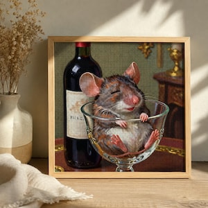 May include: A framed diamond painting featuring a brown mouse with closed eyes resting inside a clear glass goblet. Beside the glass sits a dark wine bottle with a white label. The artwork displays a grid-like texture throughout the image.