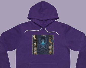 May include: A deep purple hooded sweatshirt featuring a central graphic print of a person lying in bed at night, illuminated by a smartphone screen. The illustration includes an hourglass, a crescent moon, and a rooster within a decorative frame.