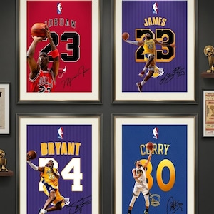 May include: Four framed basketball player posters. Michael Jordan in a red Bulls jersey with the number 23. LeBron James in a purple Lakers jersey with the number 23. Kobe Bryant in a purple Lakers jersey with the number 24. Stephen Curry in a blue Warriors jersey with the number 30.