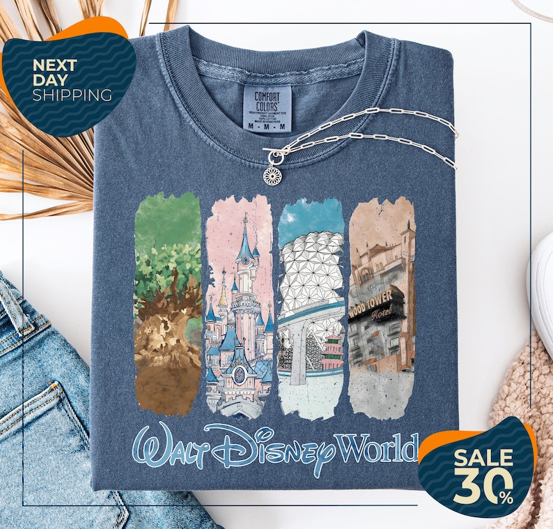 a blue t-shirt with a graphic design depicting various Disney World landmarks, including the Walt Disney World resort, the Wood Tower, and the Epcot Pavilion. The t-shirt is displayed on a white background, and there are two sale signs indicating a 30% discount on the item.