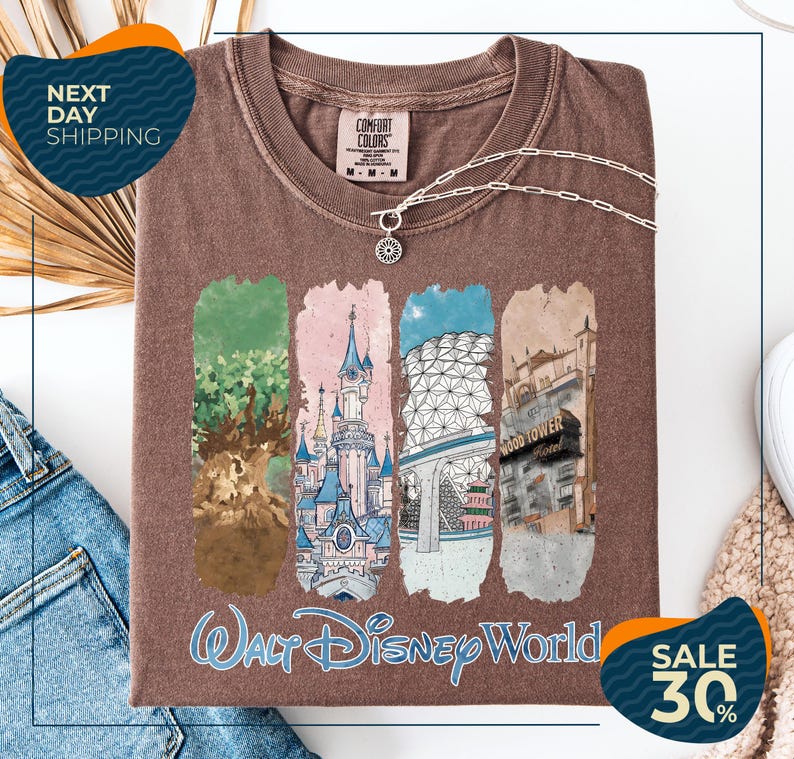 a brown t-shirt with a collage of four Disney World-themed illustrations, including a castle, a tree, a building, and a hotel. The t-shirt is displayed on a white background, and there are two sale signs indicating a 30% discount.