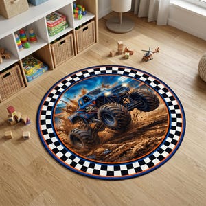 May include: A round area rug featuring a blue monster truck with the text MUD MASTER printed on the side. The truck is depicted driving through dirt with large tires and splashing mud. The rug has a black and white checkered border with an orange trim.