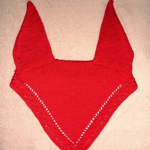 May include: A red knitted horse fly bonnet with a white lace trim.