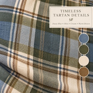 Close-up of blue and olive tartan pillow fabric showing dusty blue, olive green, cream and warm brown plaid with detailed woven texture.