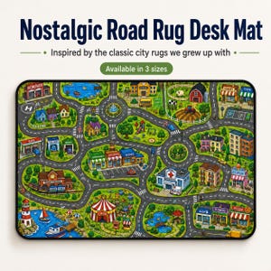 May include: A rectangular desk mat featuring a colorful illustrated city map with roads, a train station, a hospital, a circus tent, a lighthouse, a school, and various shops. The text "Nostalgic Road Rug Desk Mat" is printed above the illustration.