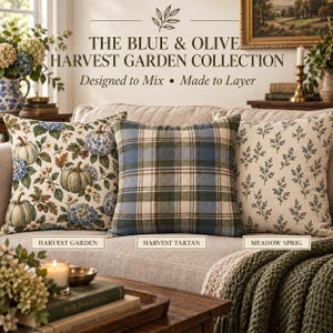 Blue and olive pillow collection featuring Harvest Garden floral pumpkin, Harvest Tartan plaid, and Meadow Sprig botanical pillow covers styled together on a cream sofa in a cozy English cottage living room.