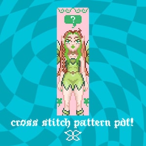 May include: A pixel art cross stitch pattern PDF featuring a green fairy with red hair and green accents. The fairy has wings and is wearing a green dress. The background is pink with a question mark and shamrocks. The text "cross stitch pattern pdf!" is at the bottom.