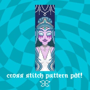 May include: A cross-stitch pattern PDF featuring a pixelated illustration of a woman with purple skin, blue hair, and a white dress. The text "cross stitch pattern pdf!" is at the bottom, with a blue and turquoise background.
