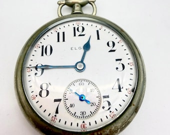 Reloj de bolsillo Elgin de 1927, tamaño 16s, grado 480, 7 rubíes, esfera plateada, escala de minutos roja.