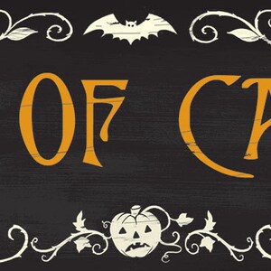 May include: A Halloween-themed sign with the words "OUT OF CANDY" in orange lettering on a black background. The sign is framed with white vines, leaves, and a bat, with a spider and a "Sorry!" sign.