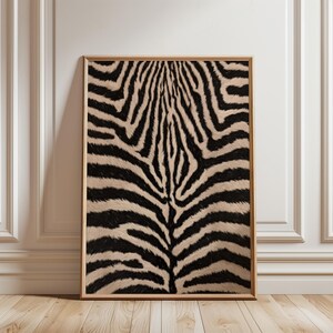 May include: A rectangular wall art print featuring a high-resolution close-up of a zebra hide pattern with bold black stripes against a light beige background, encased in a simple, thin, light-coloured wooden frame with a clean, flat edge.