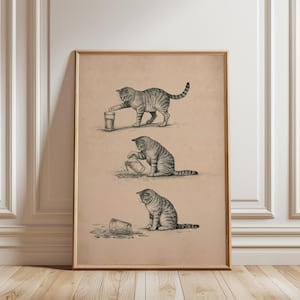 Pode incluir: Uma impressão artística vertical emoldurada sobre fundo bege com três esboços sequenciais a preto e branco de um gato malhado. O gato é mostrado a tocar num copo, a virá-lo e, finalmente, sentado ao lado da água derramada no chão.
