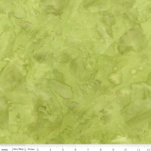 May include: A green fabric with a watercolor-like pattern. The fabric has a light green base with darker green and brown accents. The pattern is abstract and resembles brushstrokes.