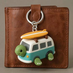 May include: A brown leather wallet featuring a metal keychain with a teal and white van-shaped charm. The van has a green turtle head protruding from the front, a yellow surfboard on the roof, and small green turtle feet at the base.