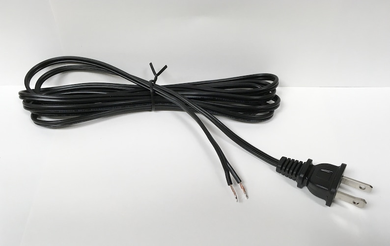 May include: A black electrical extension cord with a standard two-prong plug and exposed wire ends.