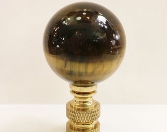 May include: A gold lamp finial with a round, polished tiger's eye stone top.