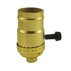 May include: A brass light socket with a black on/off switch. The socket is designed for standard light bulbs.