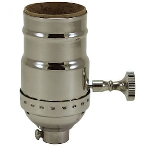 May include: A chrome-plated light bulb socket with a side switch. The socket has a threaded base and a side-mounted switch for easy on/off control.