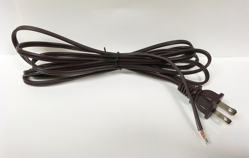 May include: A brown electrical extension cord with a standard US plug. The cord is coiled and ready to use.