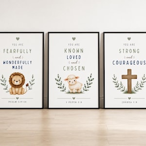 May include: Three framed wall art prints featuring religious text and illustrations. The first shows a lion with "You are fearfully and wonderfully made" and "Psalm 139:14". The second shows a lamb with "You are known loved and chosen" and "1 Peter 2:9". The third shows a cross with "You are strong and courageous" and "Joshua 1:9".