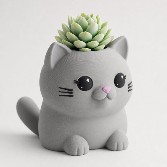 Three-quarter close-up of the Whisker Sprout cat planter in Ash Gray