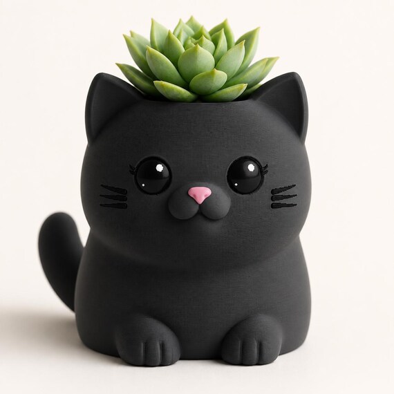 Close-up of the Whisker Sprout cat planter in Charcoal with a compact succulent