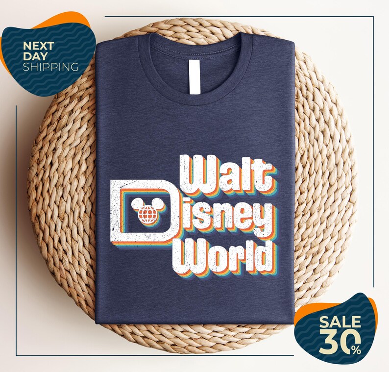 A dark blue t-shirt with the text "Walt Disney World" printed on it, placed on a woven basket.