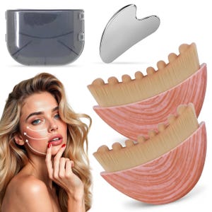 May include: A set of two semi-circular makeup brushes with pink marbled handles and dense tan bristles, a silver heart-shaped gua sha tool, and a translucent gray plastic storage case, shown alongside a face with white directional arrows.