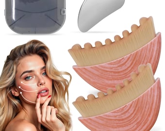May include: A set of two semi-circular makeup brushes with pink marbled handles and dense tan bristles, a silver heart-shaped gua sha tool, and a translucent gray plastic storage case, shown alongside a face with white directional arrows.