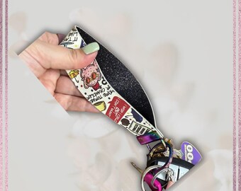 May include: A white lanyard with a black glitter backing, featuring cartoon graphics and text. The lanyard has a variety of keys and keychains attached. The text includes "I wish I could but I don't want" and "More Turkey Chandler".