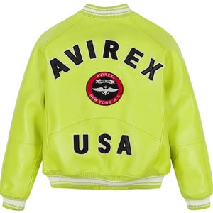 May include: A neon yellow bomber jacket featuring the black text AVIREX arched above a circular red, white, and black patch with an anchor emblem, and the black text USA below. The jacket has white and neon yellow striped ribbed trim at the collar.